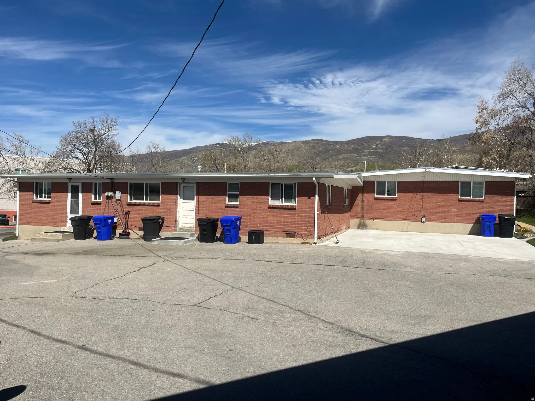 Rear view of property featuring brick siding and a mountain view