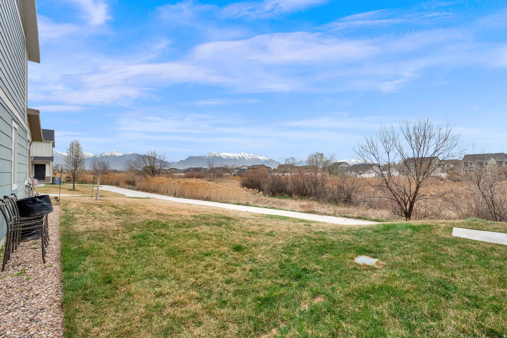 View of green lawn featuring a mountain view