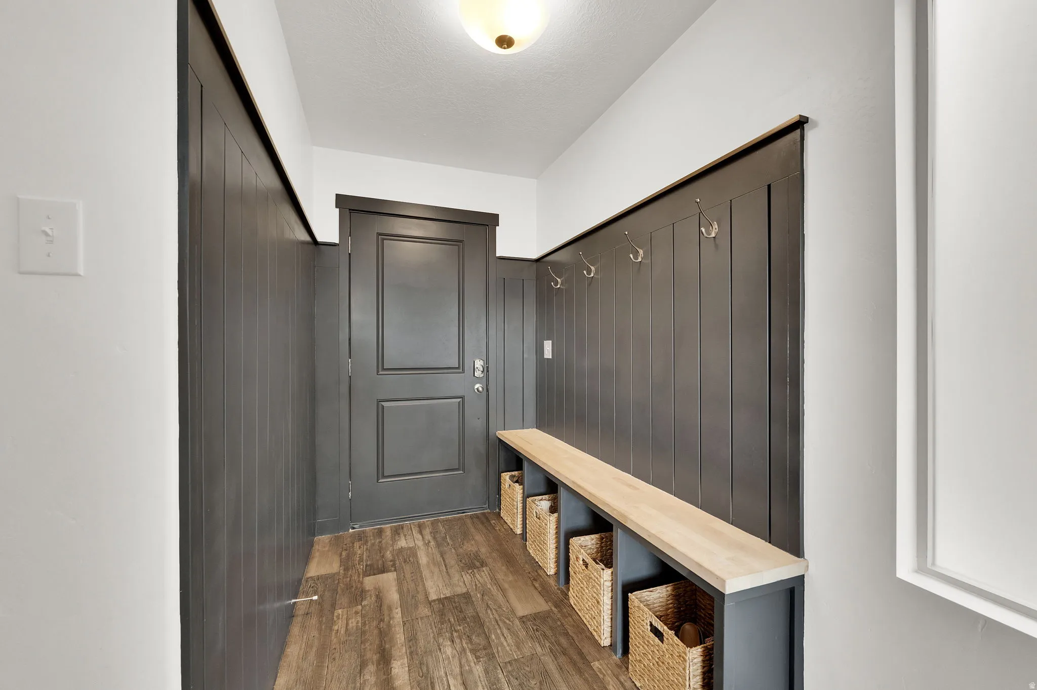Mudroom with dark wood-style flooring