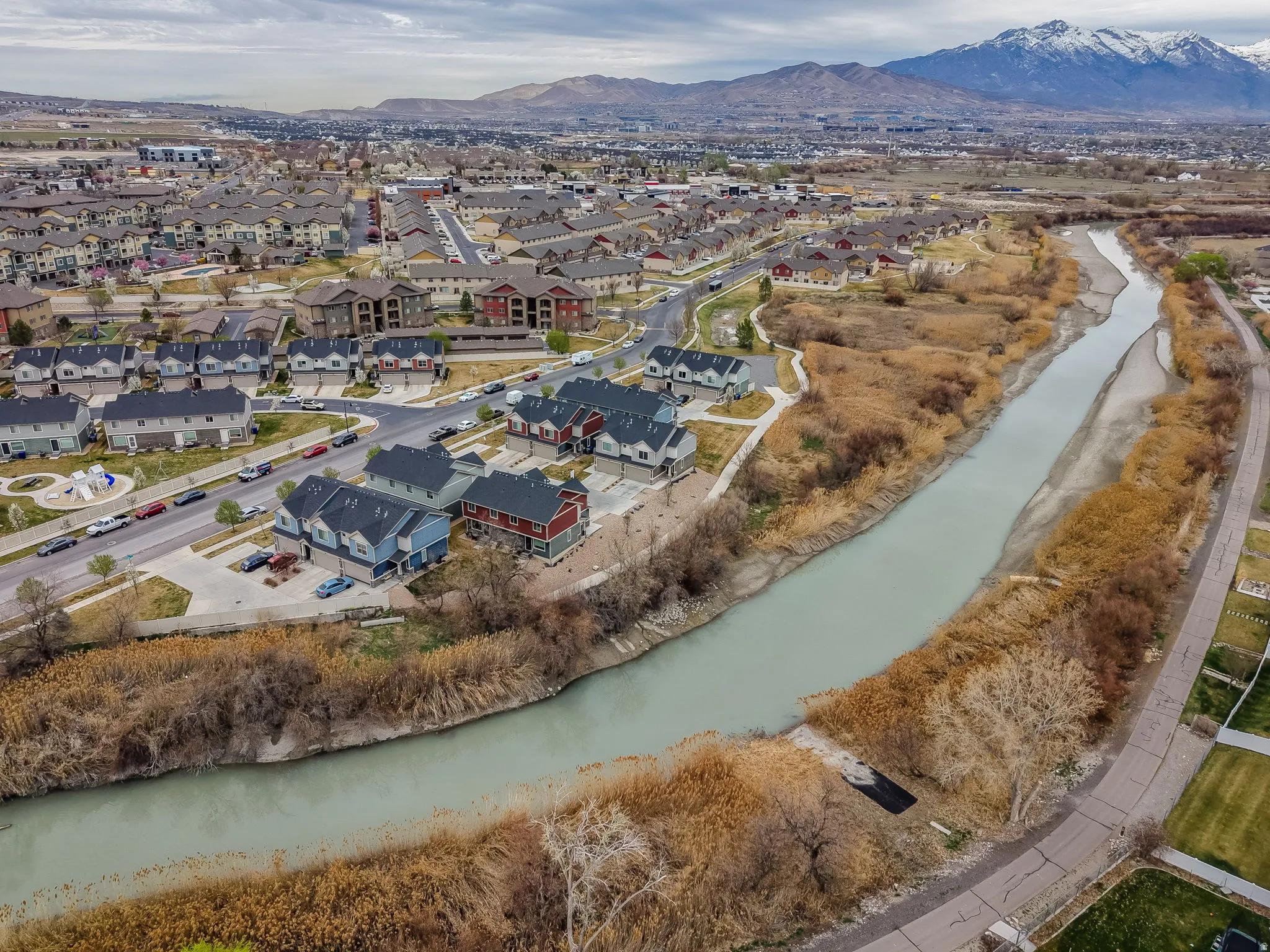 Aerial perspective of suburban area with a water and mountain view