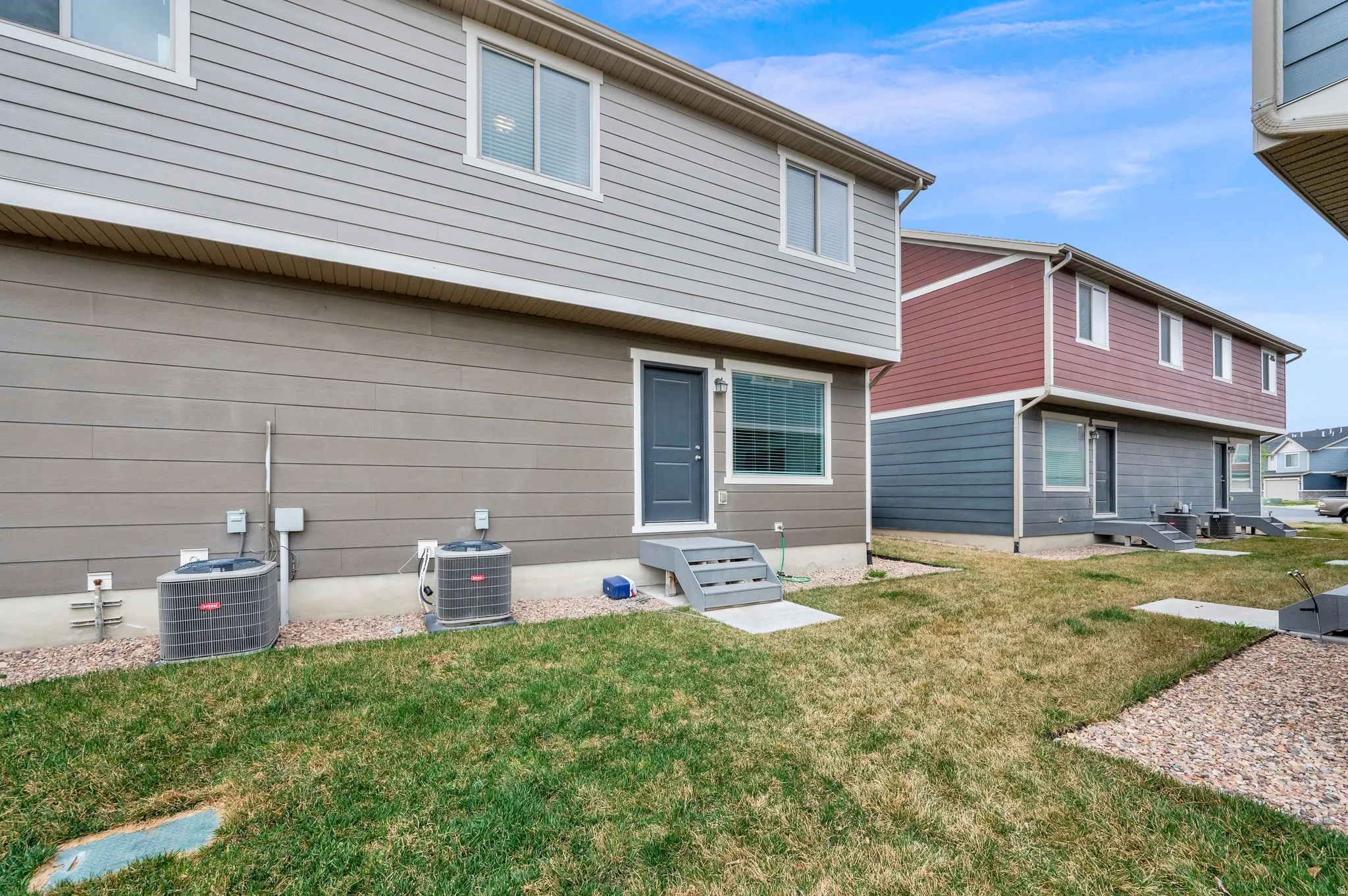 Back of house with a yard