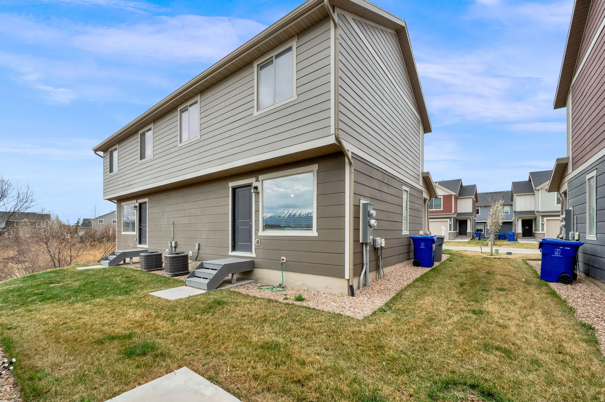 Back of property with a lawn