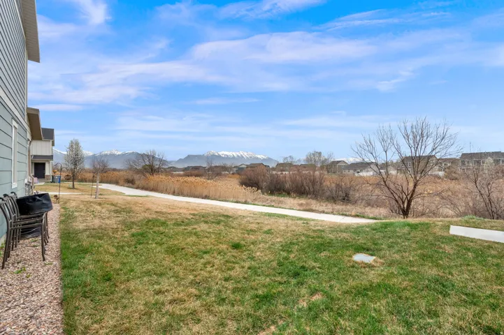 View of green lawn featuring a mountain view