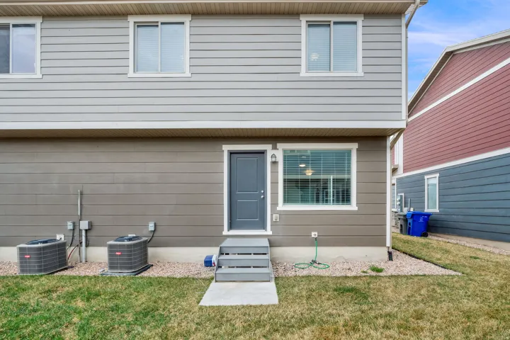 Back of house featuring a yard