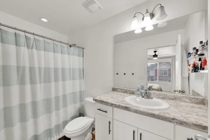 Bathroom featuring ensuite bathroom, vanity, a shower with shower curtain, recessed lighting, and ceiling fan
