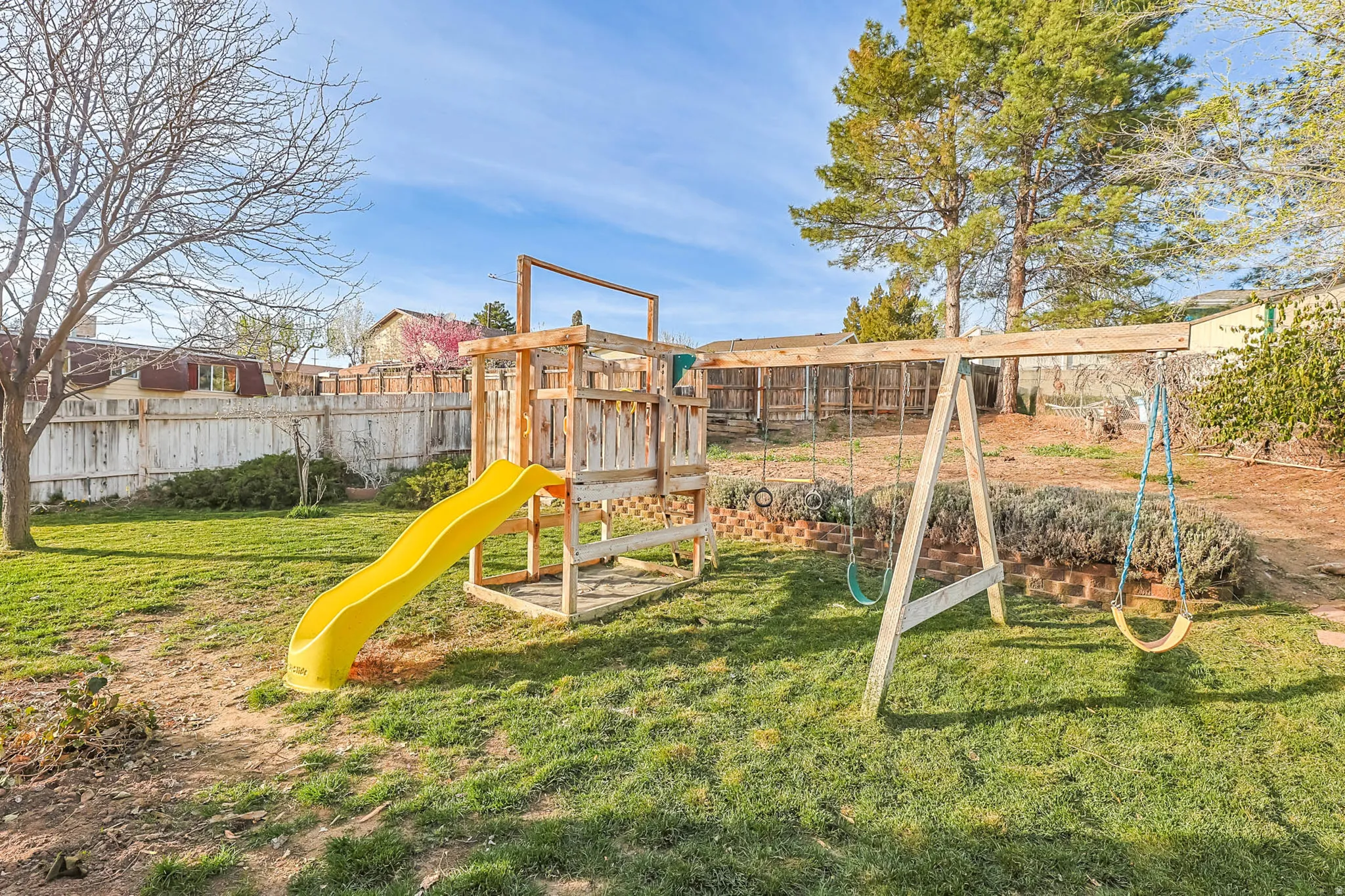 View of playground featuring a fenced backyard