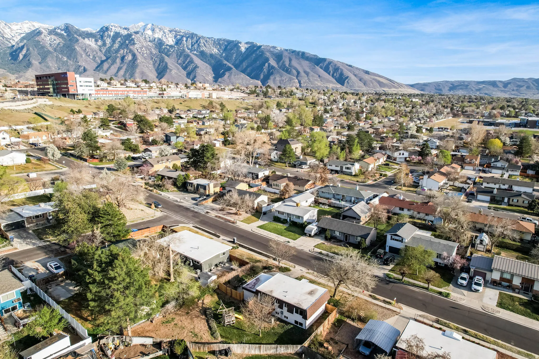 Aerial view of residential area featuring a mountainous background