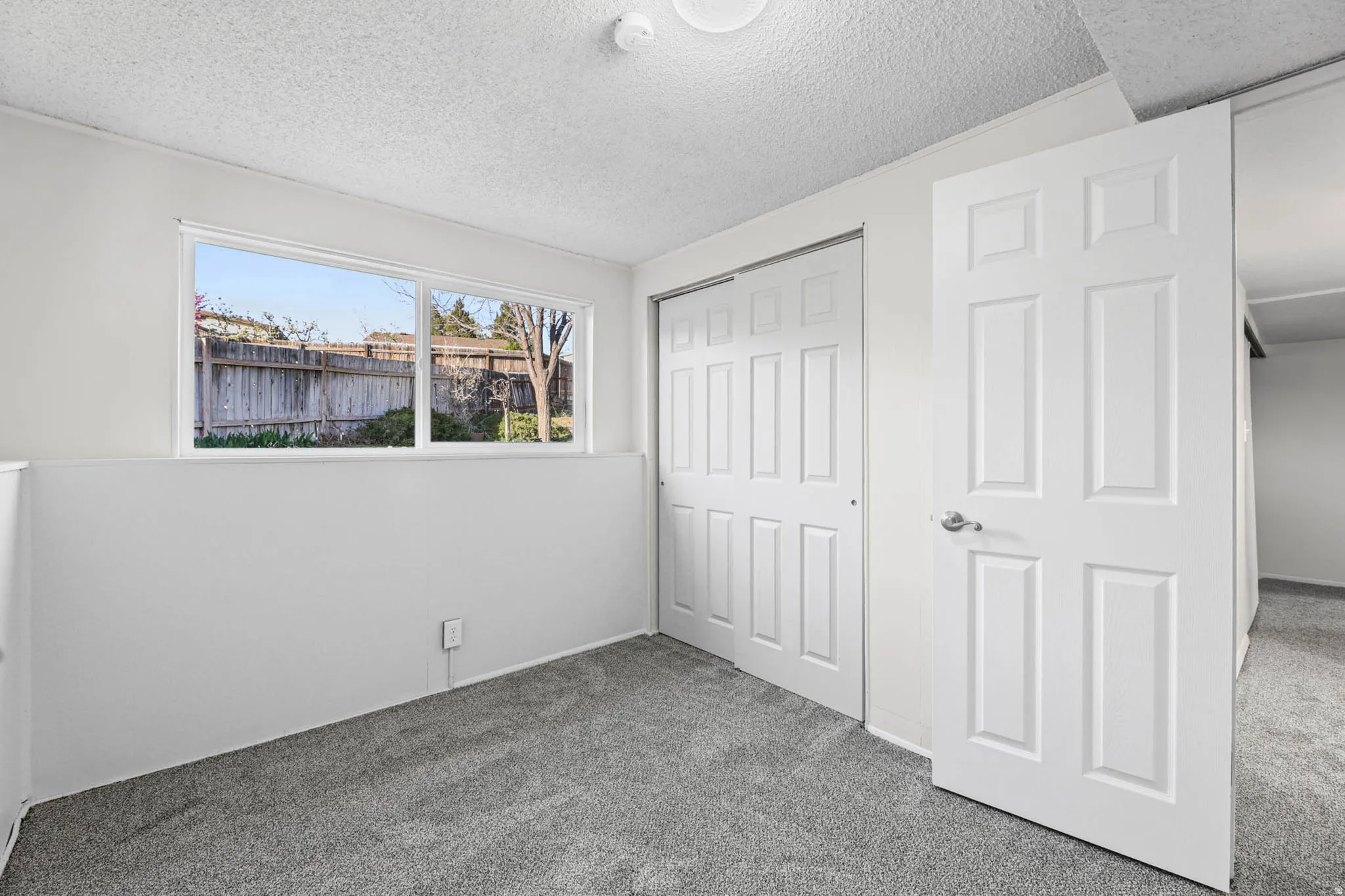 Unfurnished bedroom featuring carpet, a closet, and a textured ceiling