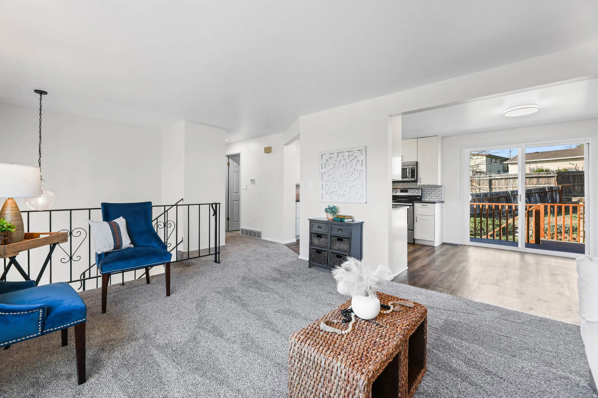 Living room featuring light carpet, natural light, located just off kitchen dining area.