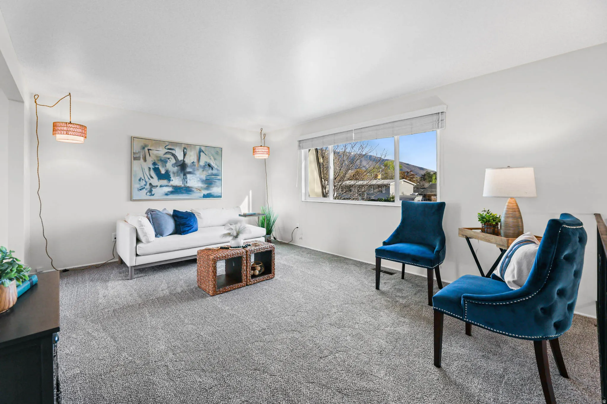 Living room with newly carpeted floors, large window, lots of light and spacious feel.