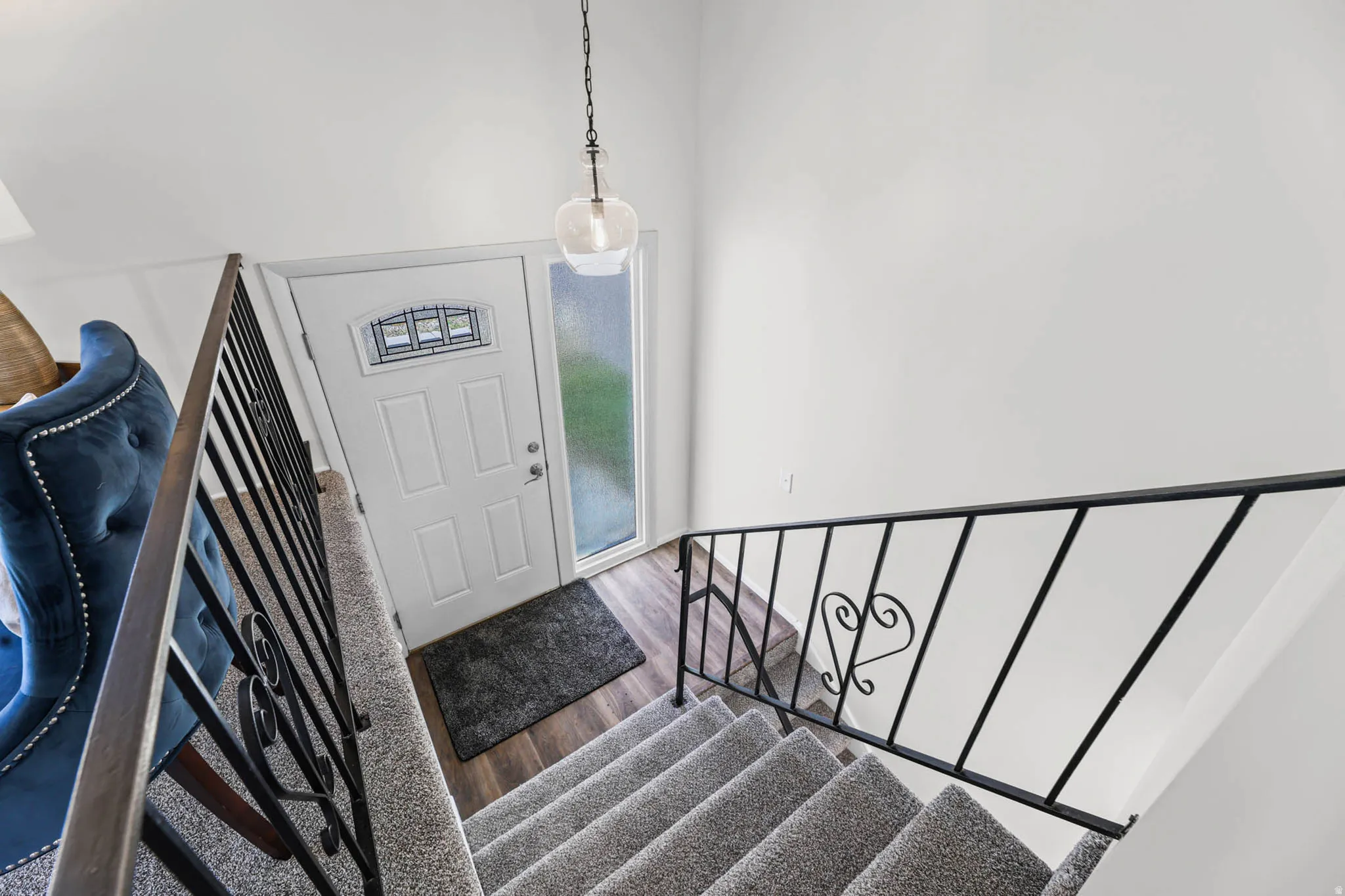 Stairway with vinyl floors and a high ceiling