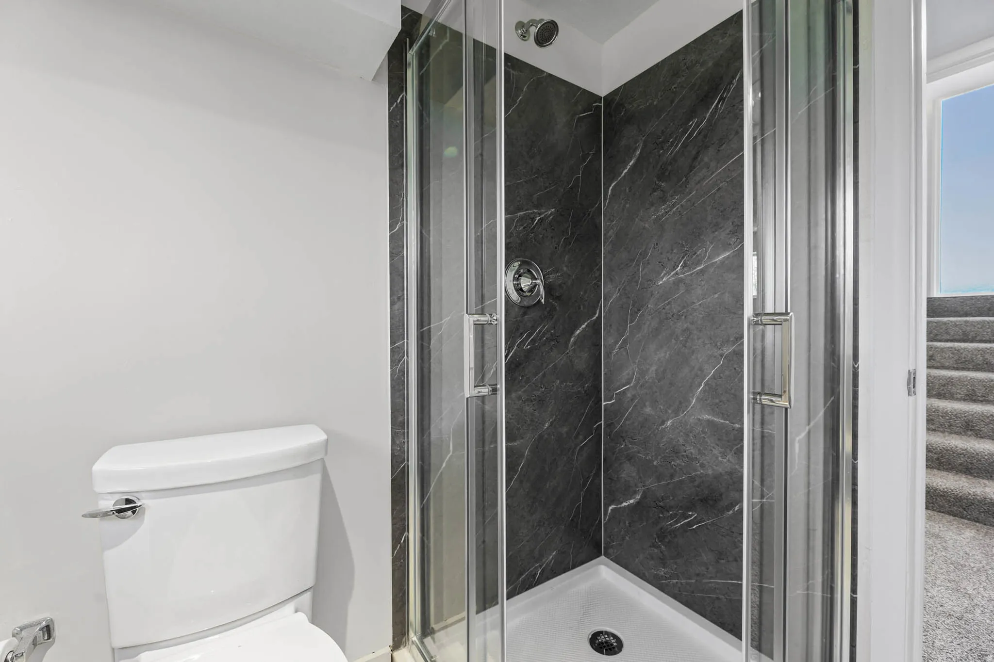 Bathroom featuring a marble finish shower