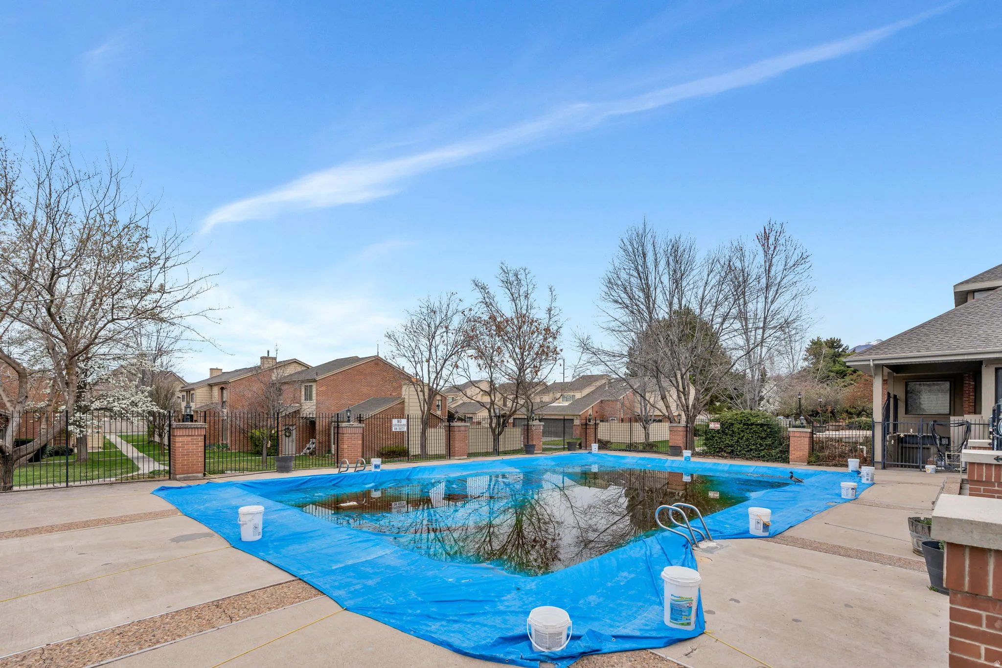 Community pool featuring a residential view and a patio