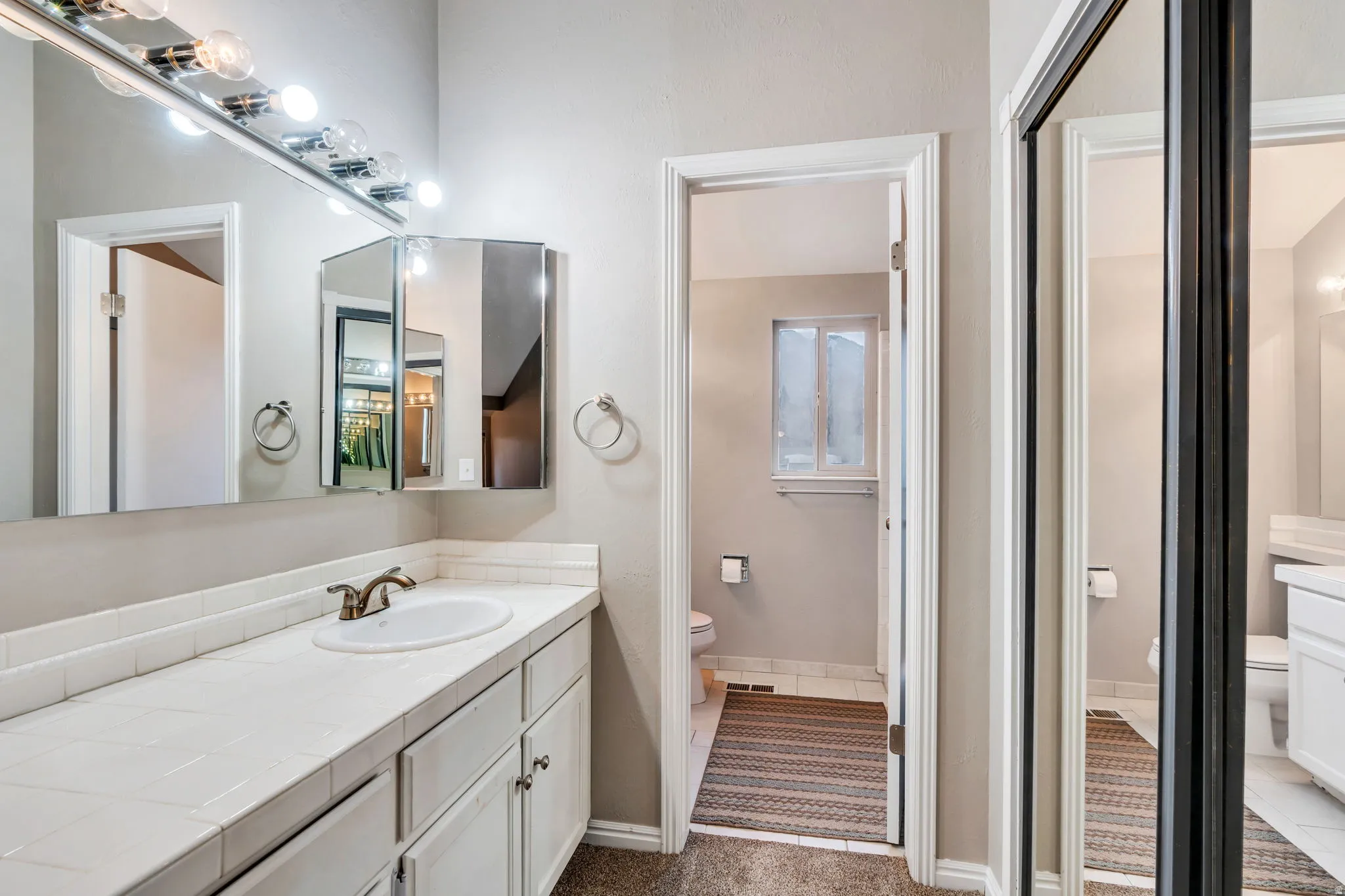 Full bathroom with toilet and vanity