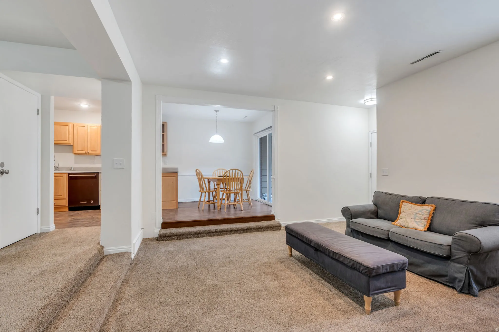Living area featuring recessed lighting and light carpet