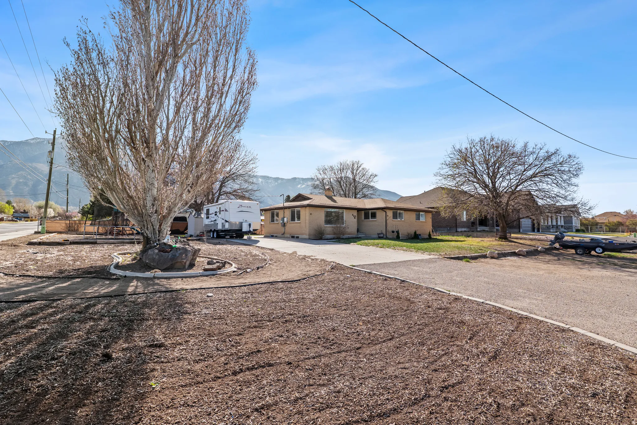 Single story home with concrete driveway and a residential view