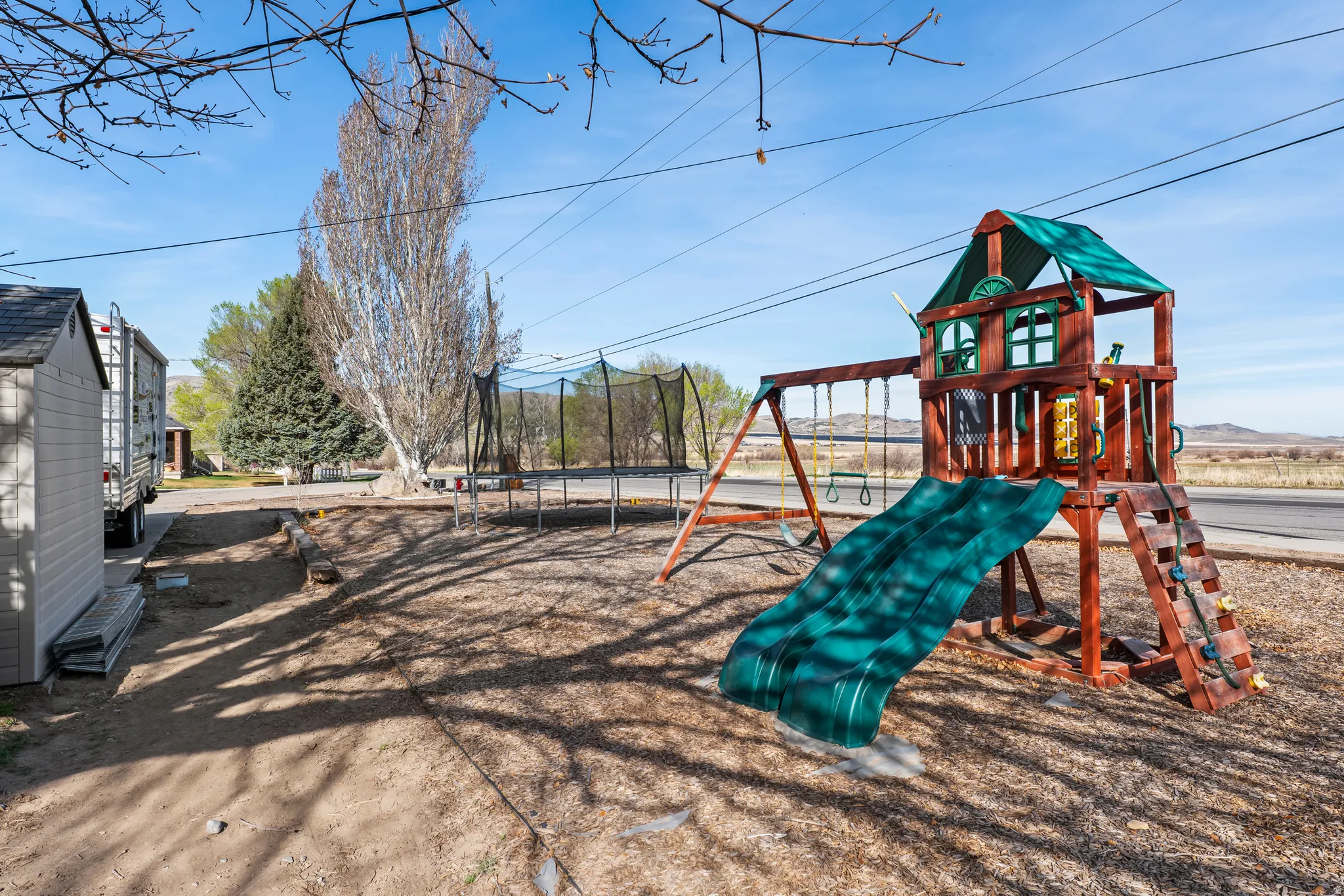 View of jungle gym featuring a trampoline