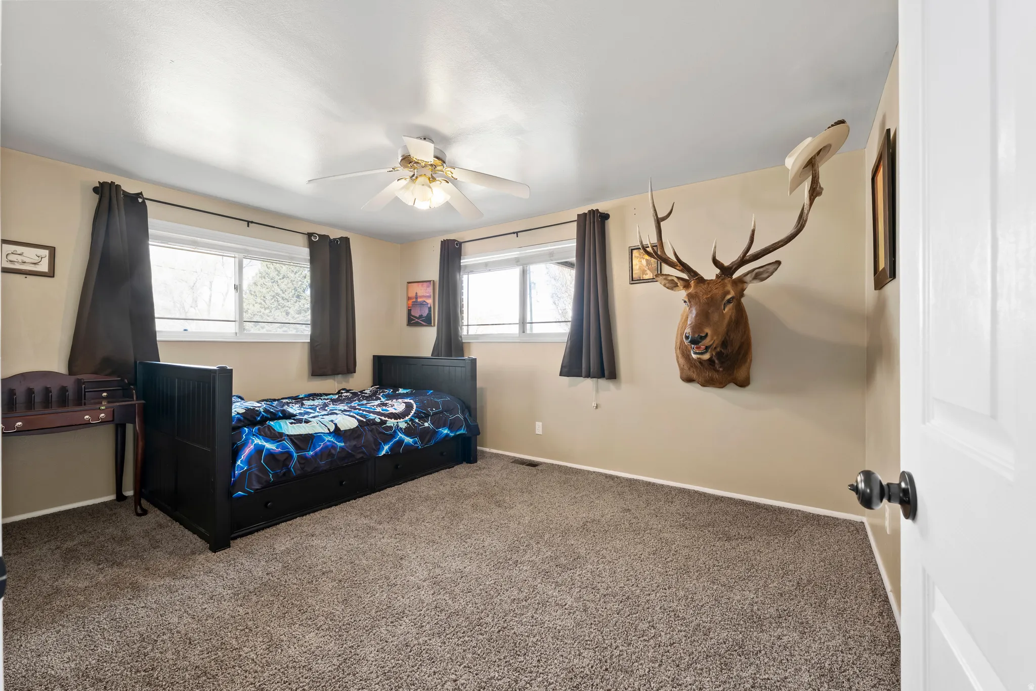 Bedroom with carpet and ceiling fan