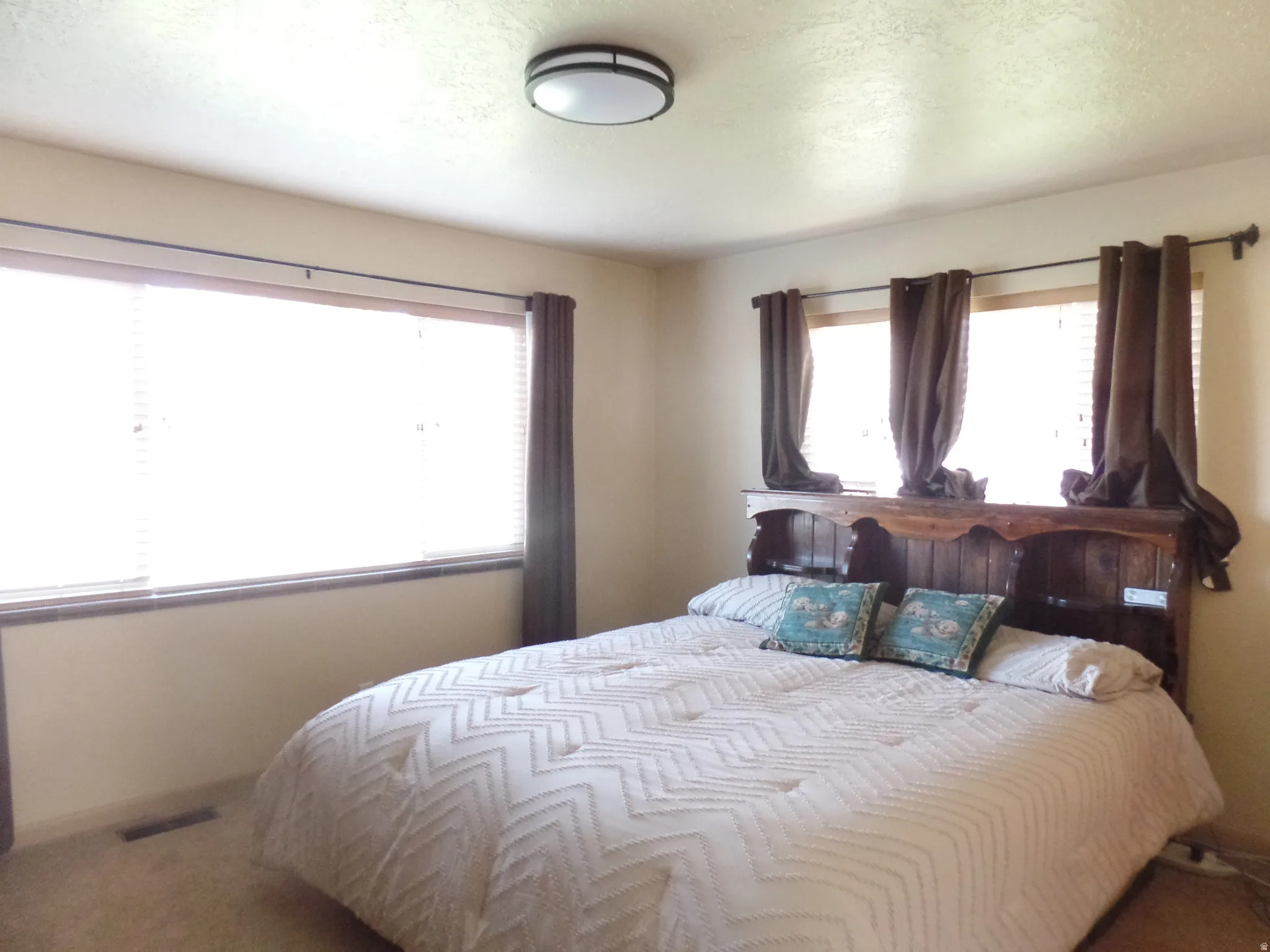 Carpeted bedroom with a textured ceiling