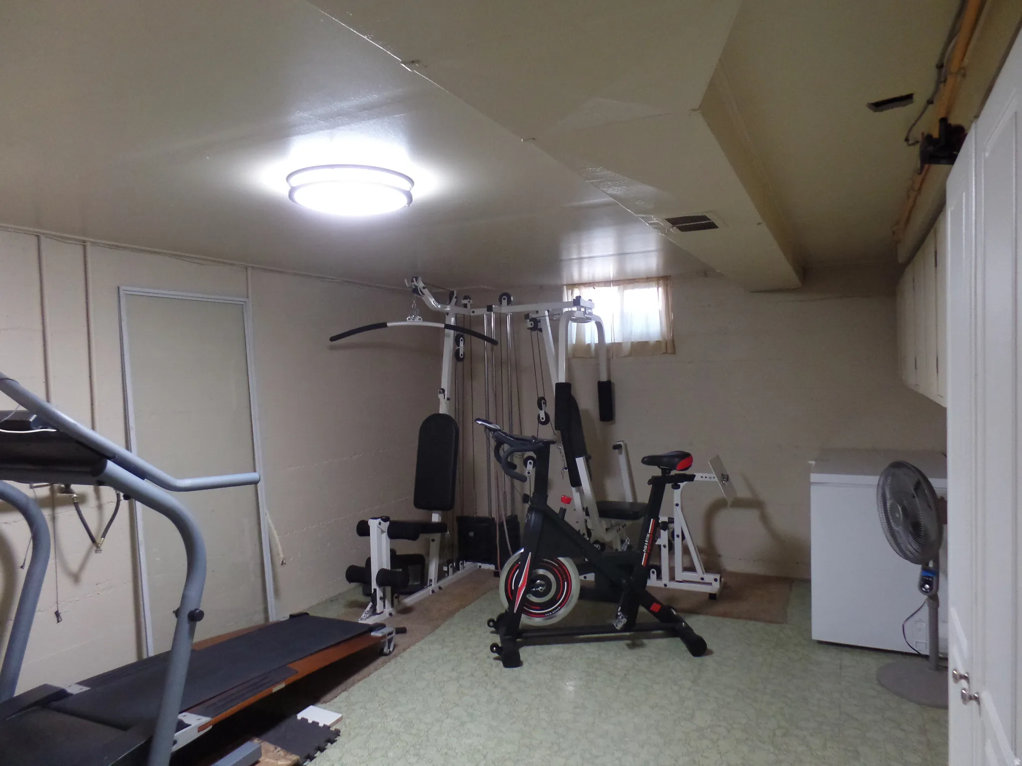 Workout area with light flooring and concrete block wall