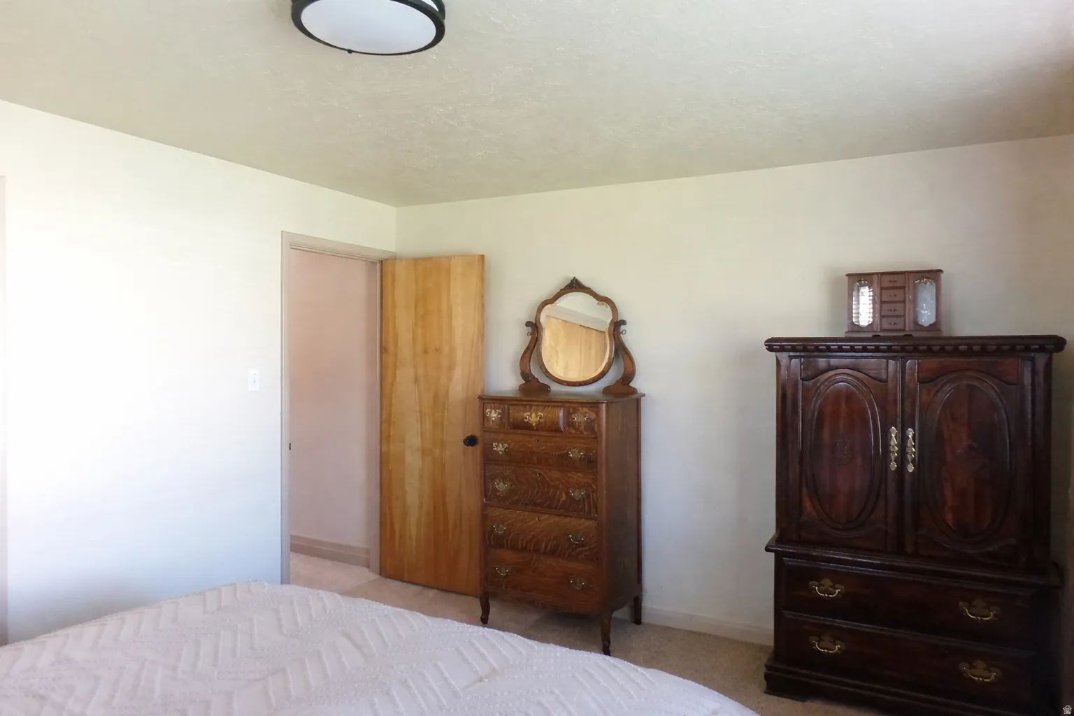 Bedroom featuring light carpet
