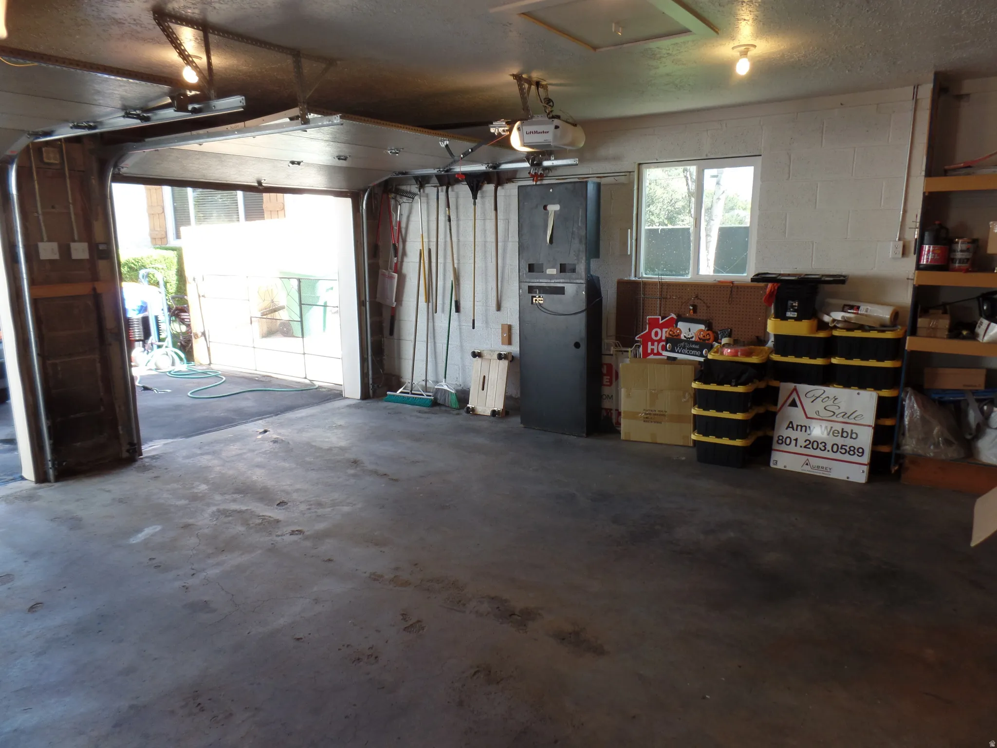 2 car Garage with concrete block wall and a garage door opener