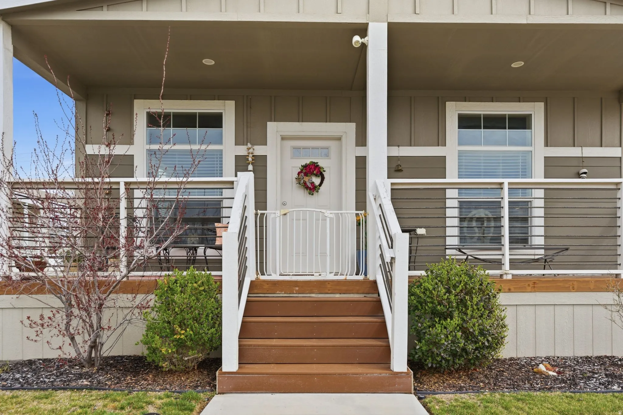 Entrance to property featuring board and batten siding and a porch