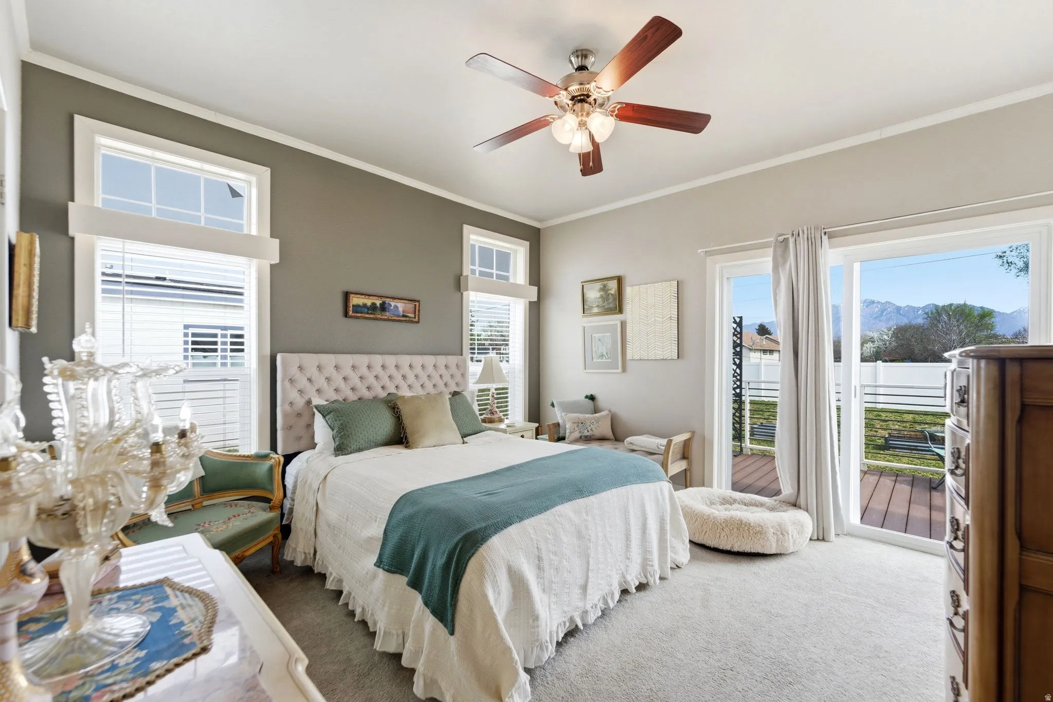 Bedroom featuring carpet floors, access to outside, crown molding, a mountain view, and ceiling fan