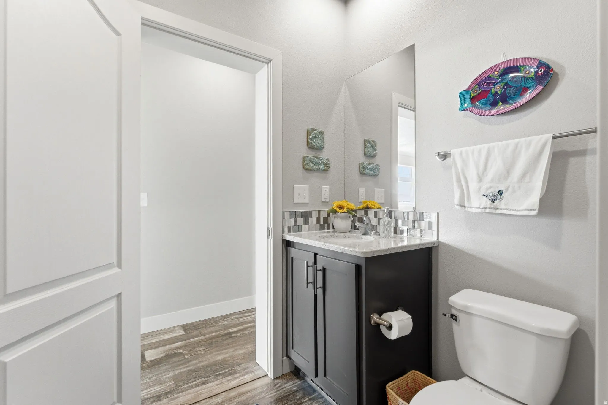 Half bathroom featuring vanity and light wood-type flooring