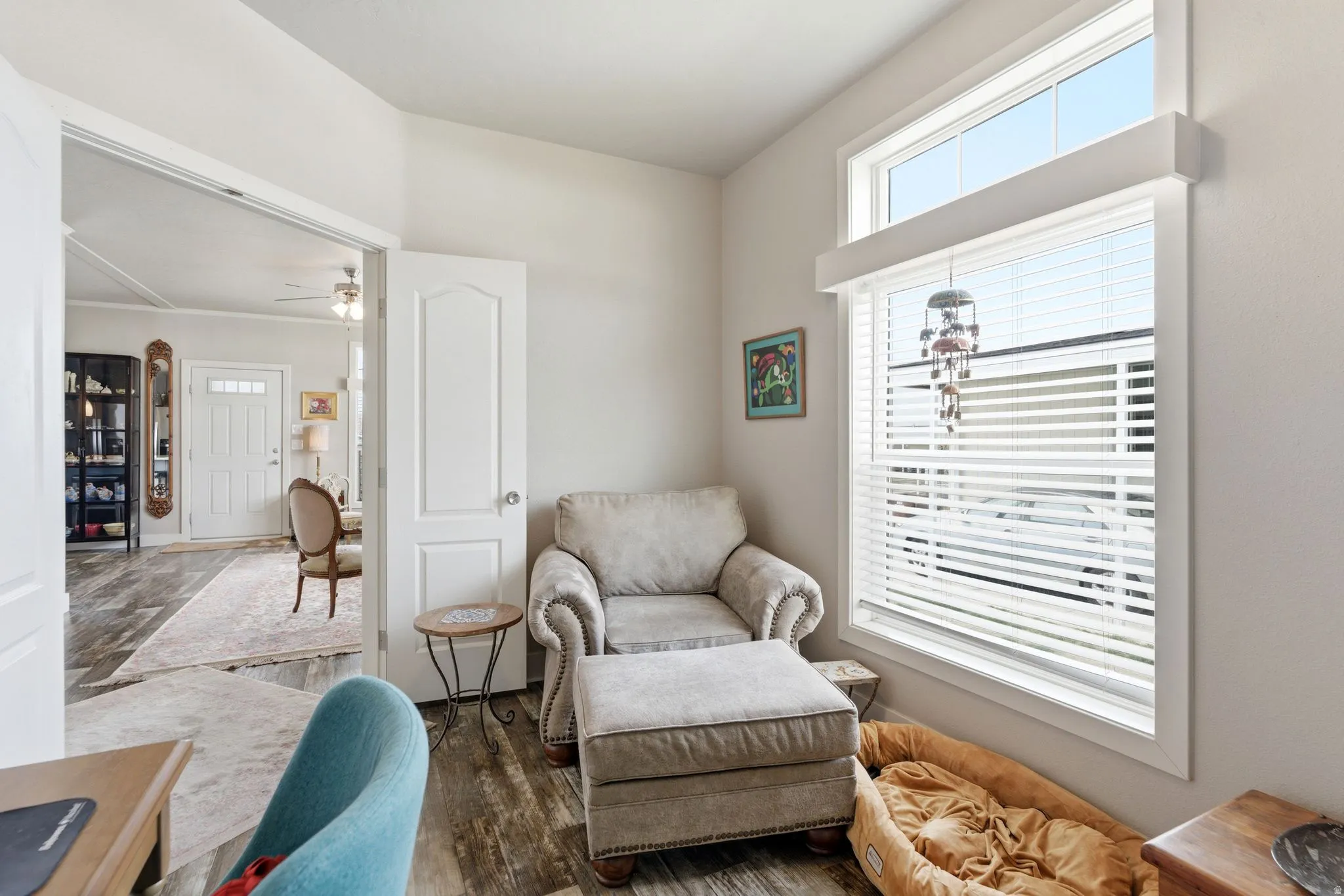 Sitting room with wood finished floors and ceiling fan