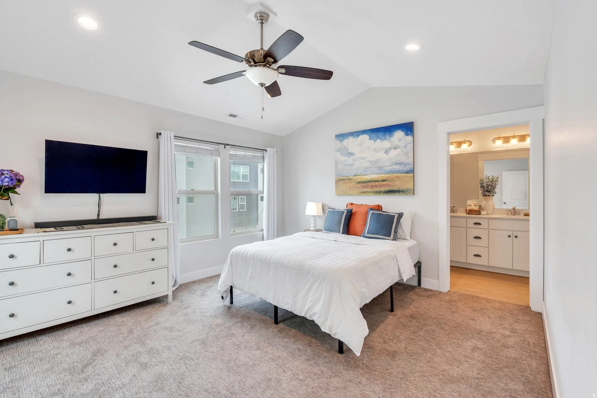 Primary Suite offering plush carpeting, abundant natural light, and a relaxing atmosphere with vaulted ceilings!