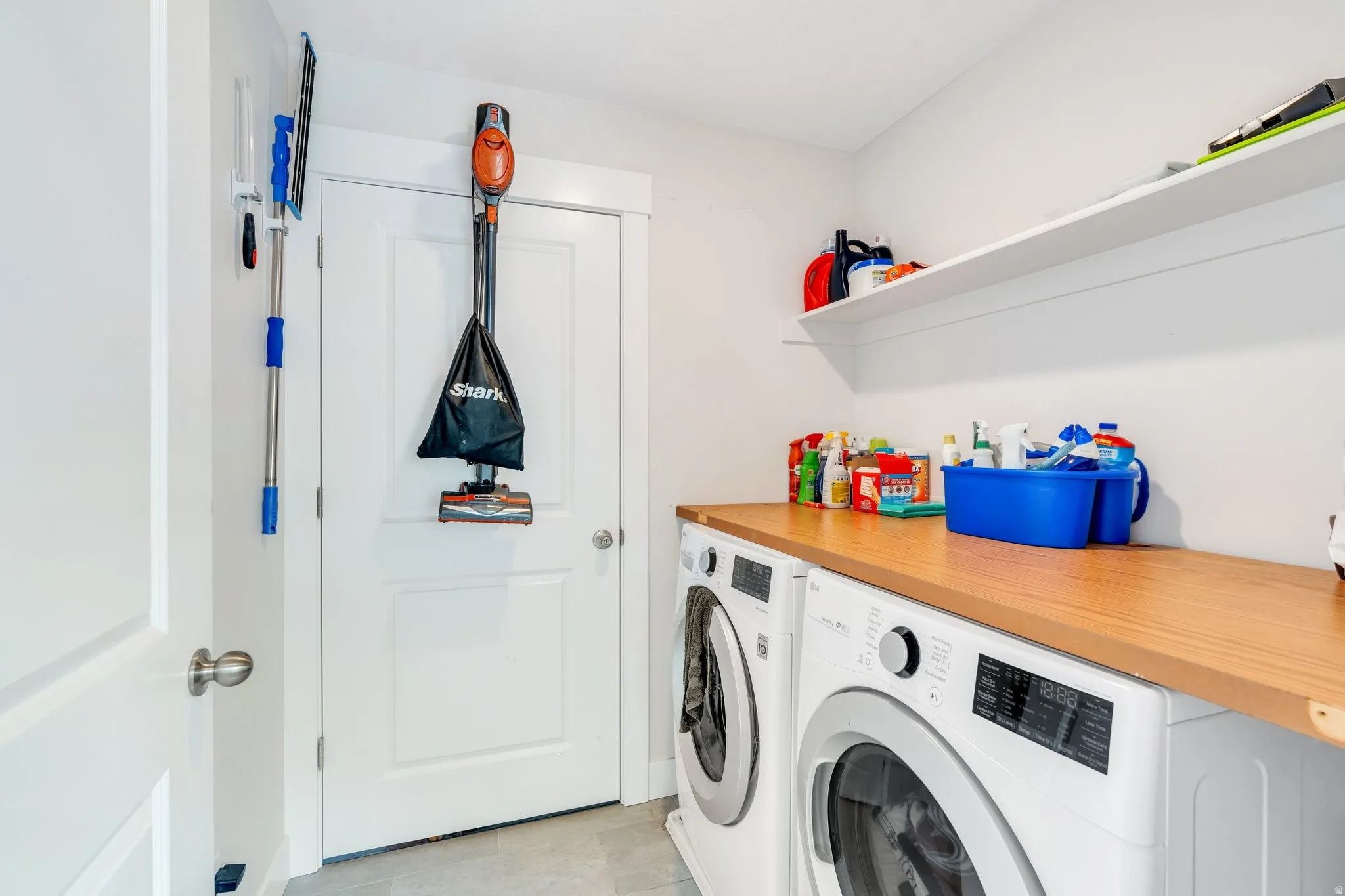 Laundry room featuring custom shelves, providing ample storage space to keep your home neat and efficient.