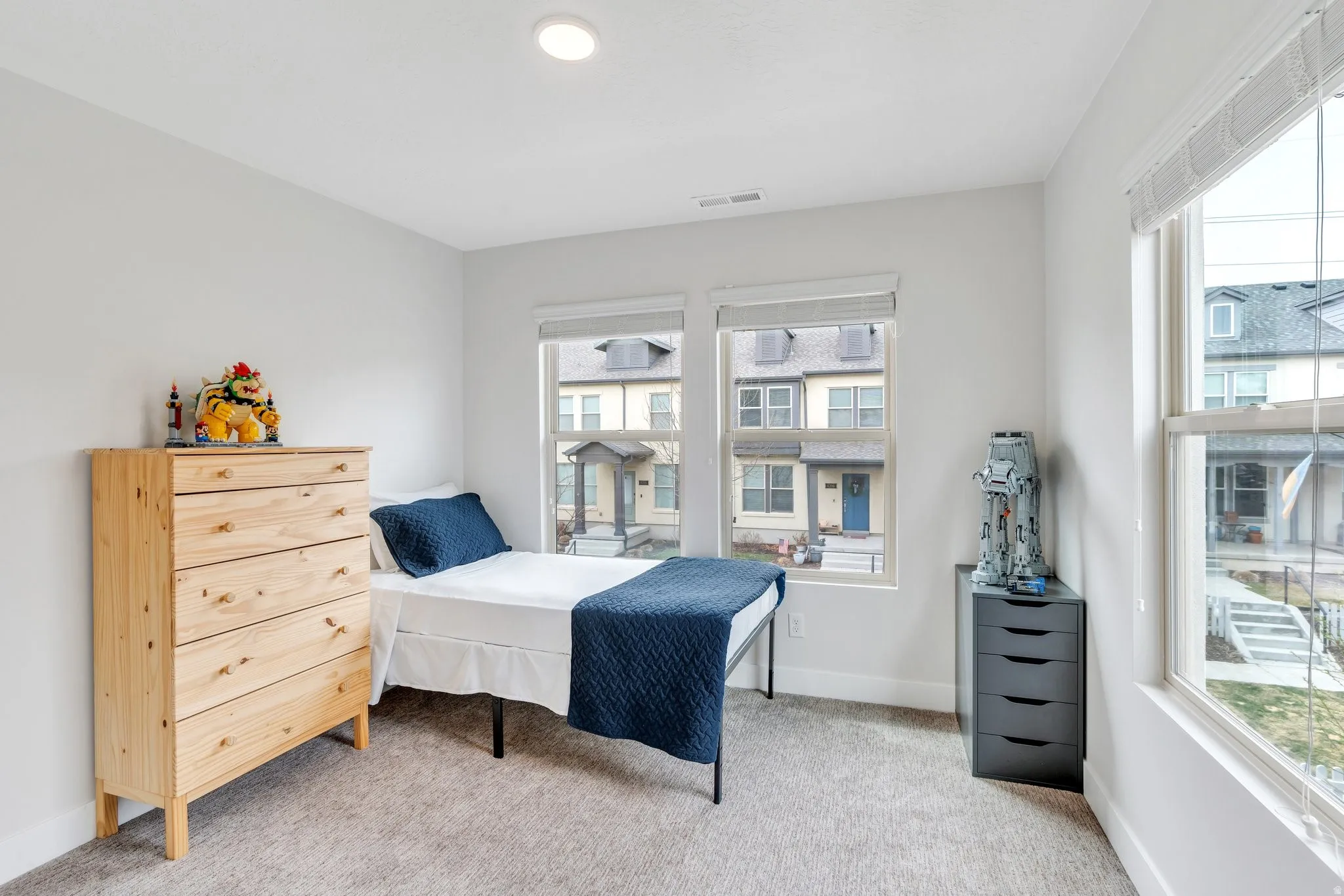 Bedroom featuring light colored carpet