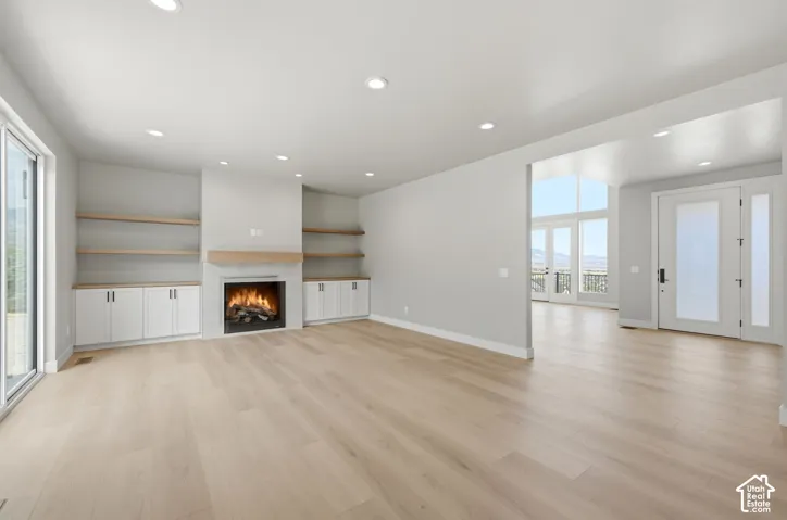 Great room with gas fireplace and built in shelving.