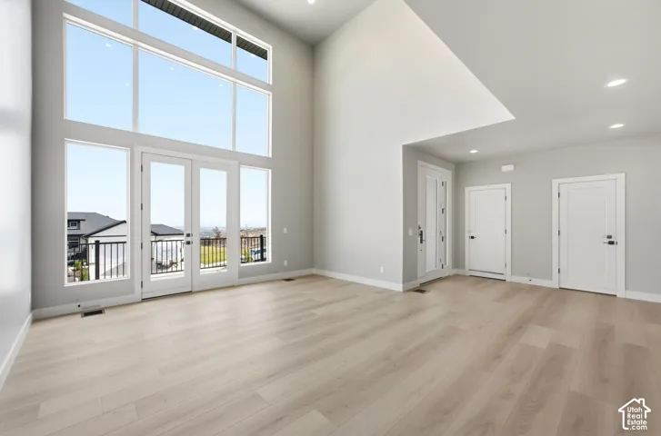 Open and Bright living room. Soaring ceilings with floor to ceiling windows and doors leading to deck that has expansive views to the north.