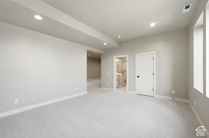 Large extra room in basement that leads to a beautiful bathroom and storage
