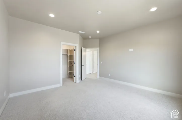 Large bedroom with walk in closet and plenty of natural light