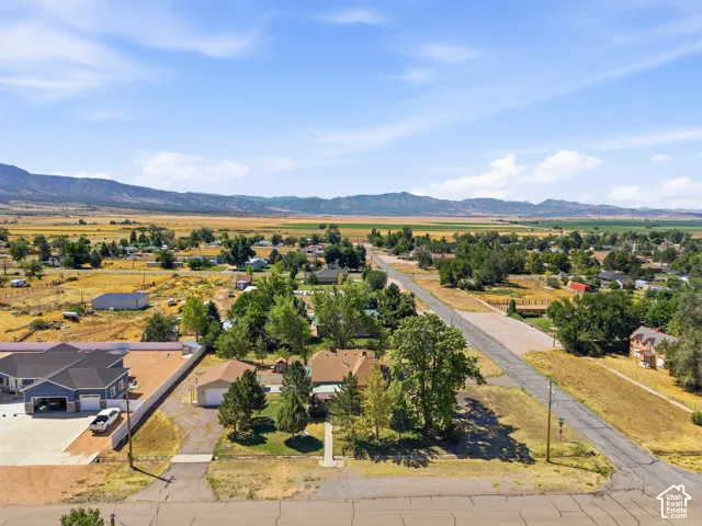 Expansive rural landscape featuring distant mountains and agricultural fields