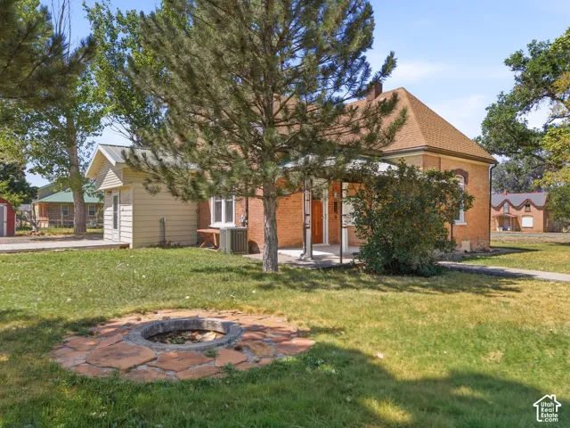 Brick exterior residence with a covered porch and an adjacent outbuilding