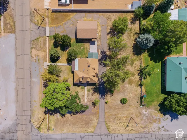 Aerial perspective showcasing a property with a main residence and a detached structure