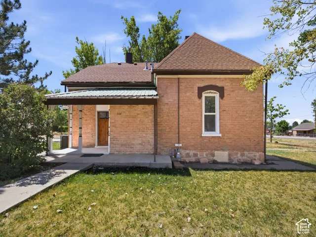Brick exterior featuring a covered porch with supporting pillars