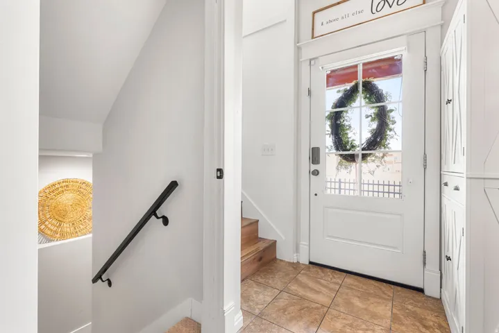 Entryway with lofted ceiling and light tile patterned floors