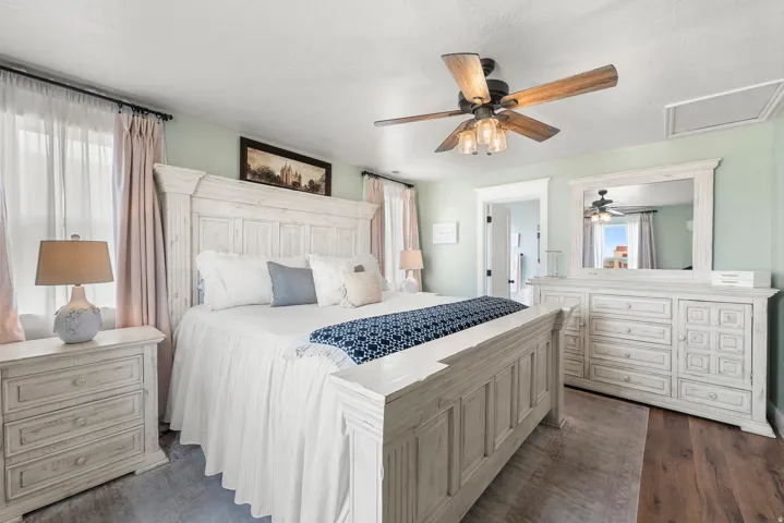 Bedroom with ceiling fan and dark wood-style floors