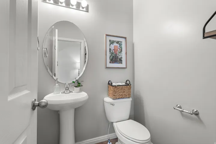 Half bath featuring toilet and baseboards