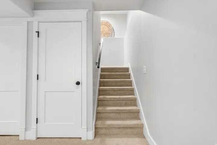 Stairway featuring carpet and baseboards