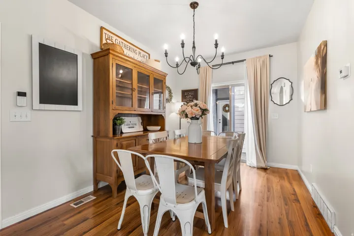 Dining space featuring hanging lights and wood finished floors