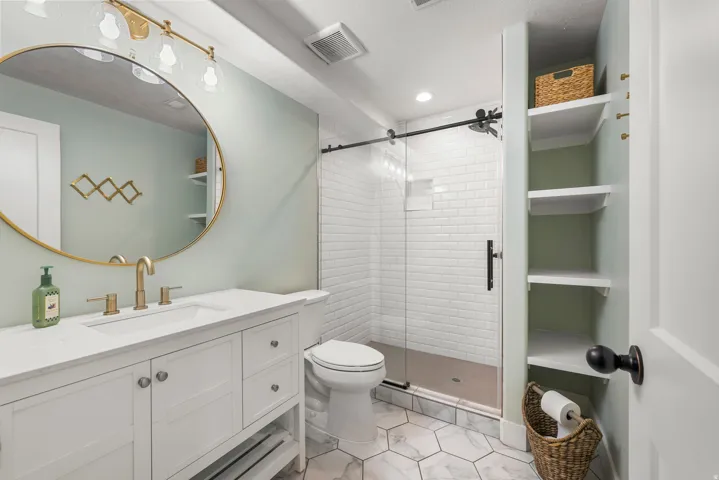 Full bathroom with vanity and a stall shower