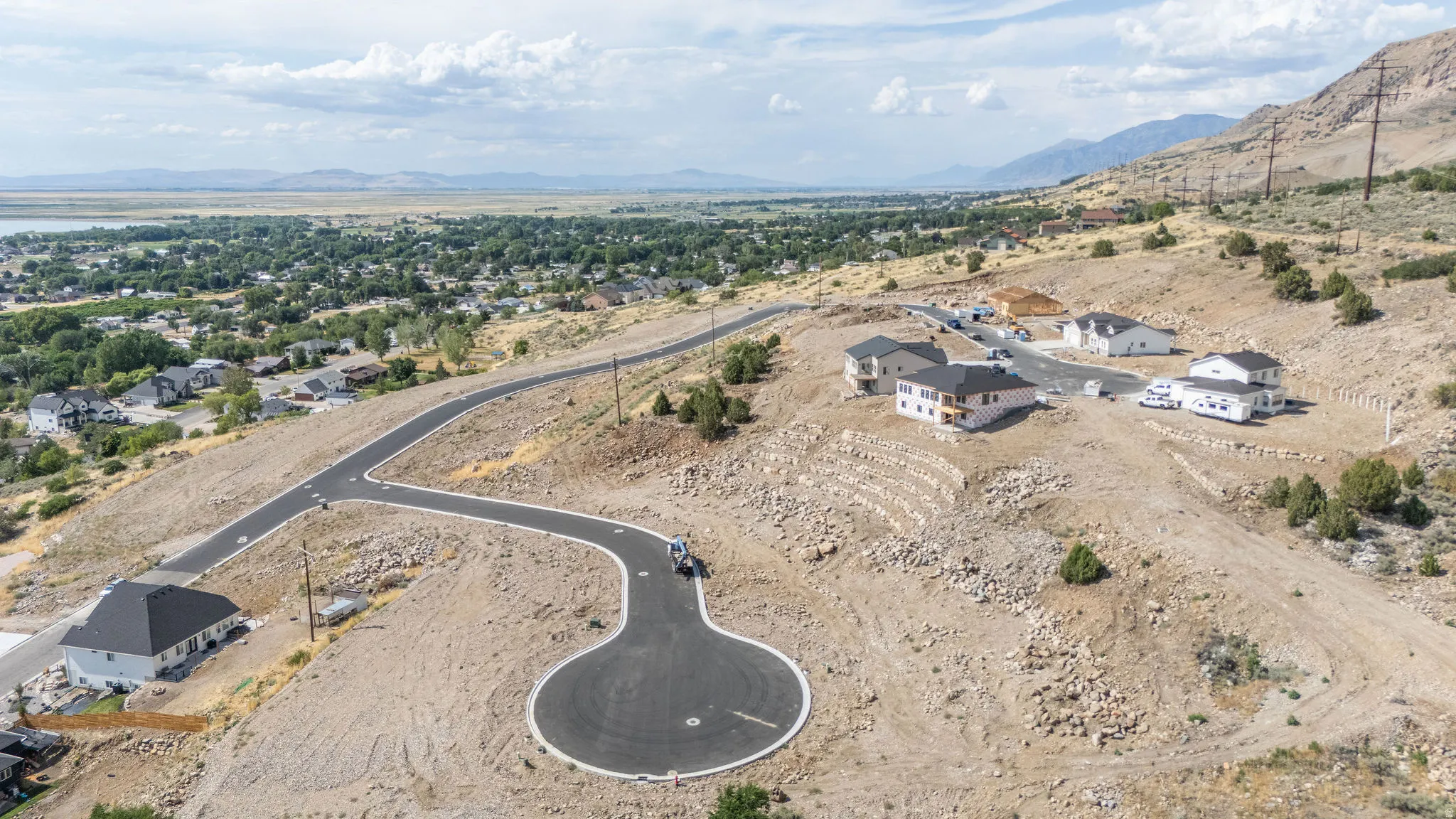 Terraced hillside development featuring newly paved streets and cul-de-sac