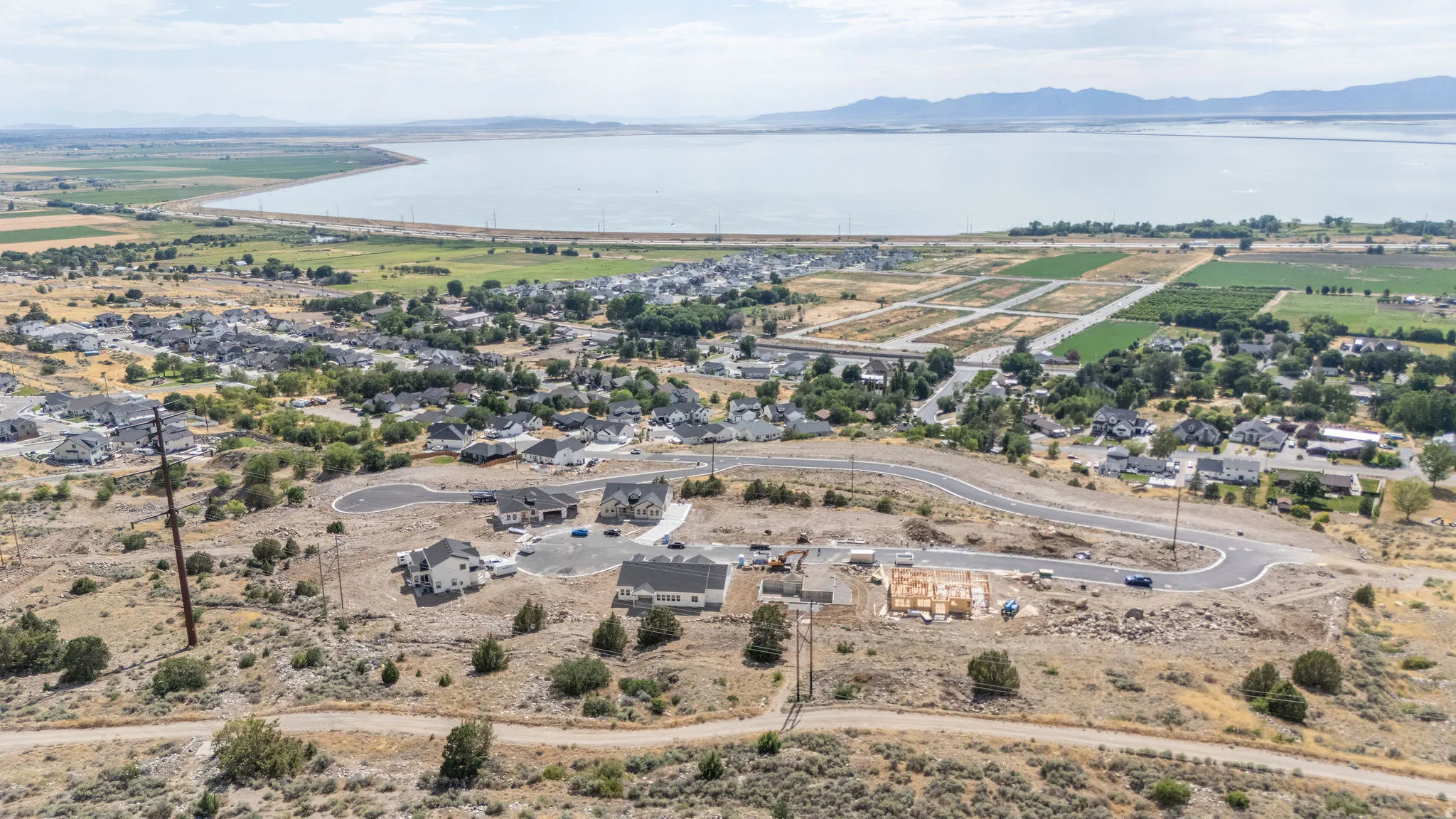 Expansive community with varied architectural styles, curved roadways, and new construction sites