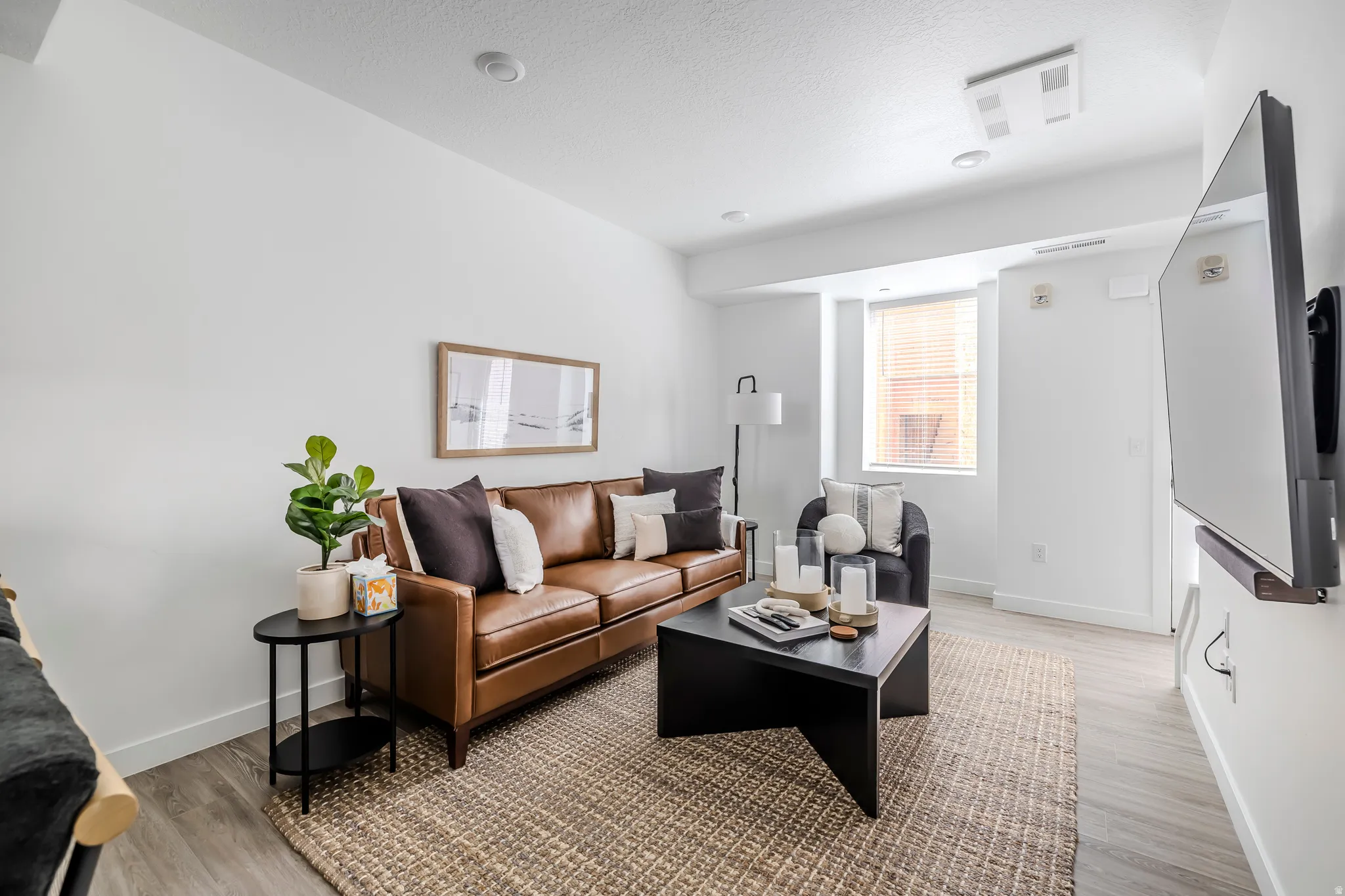 Living area featuring baseboards and light wood-style floors